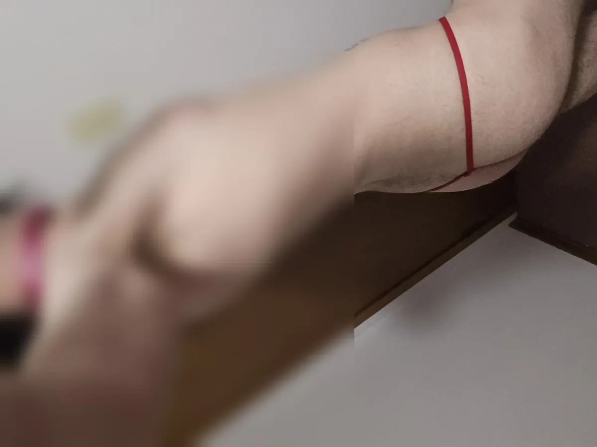 Cropped, blurred photo of a person in a red strap top for an online fetish community page Cropped, blurred photo of a person in a red strap top for an online fetish community page